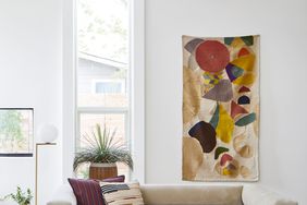 neutral-colored living room with colorful textile accent pieces
