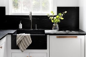 deep black marble kitchen sink white cabinets