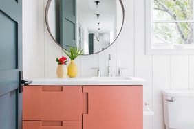 bathroom update round mirror red cabinets