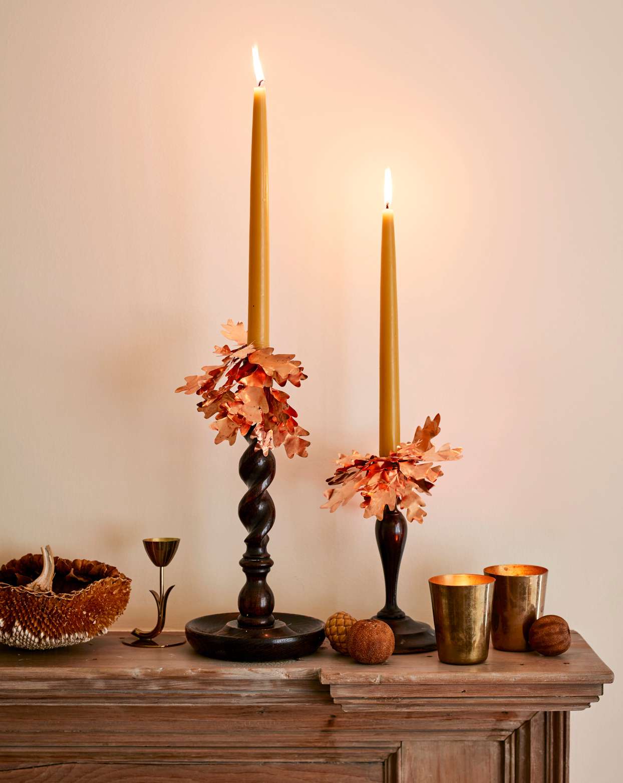candles with autumn leaf adornments