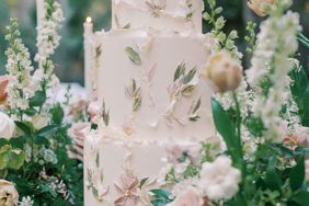 three-tiered wedding cake with frosting flowers