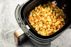 Air Fryer with cooked potatoes