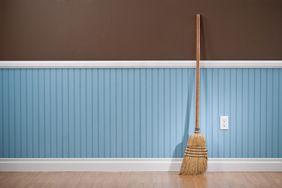 broom leaning against clean interior wall