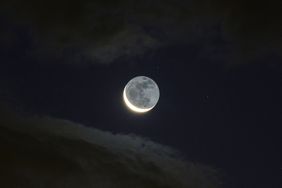 Earthshine lights the dark side of the moon on the waxing crescent moon