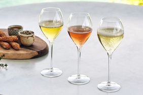 three glasses of bubbly cava on table background