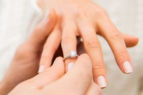 engagement-ring-stock-photo-man-putting-ring-on-womans-hand-1215.jpg