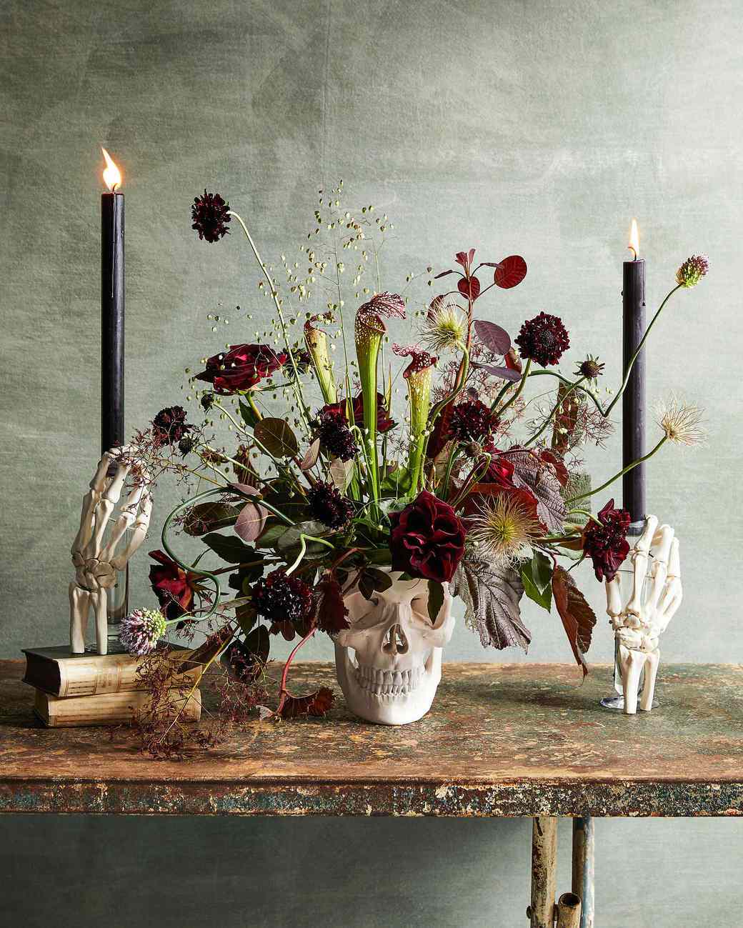floral skull and skeleton hands centerpiece on table