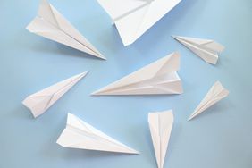 folded paper airplanes on blue surface
