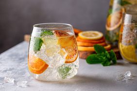 Fresh cocktail with crushed ice, mint leaves and divers oranges.