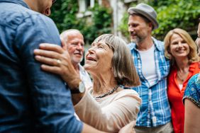 Grandmother surrounded by family at family gathering