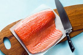 Raw Salmon on cutting board with knife