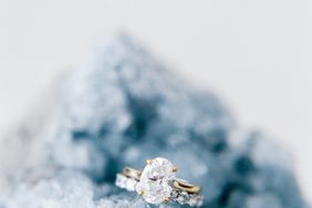 wedding rings displayed on blue crystal