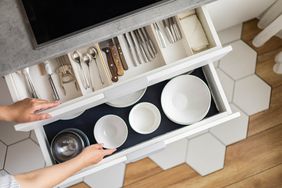 kitchen drawers with bowls and utensils