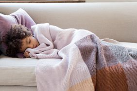 child sleeping in a knit blanket