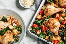 plate and sheet of chicken and kale dinner on marble table top