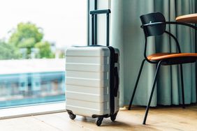 Packed suitcase in modern hotel room