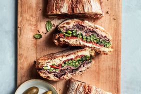 pressed sandwich with prosciutto and broccoli rabe recipe on wooden cutting board