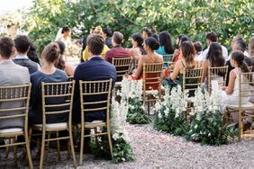 wedding guests sitting in chiavri chairs during ceremony