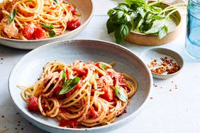 spaghetti and no-cook tomato-tuna sauce topped with basil leaves