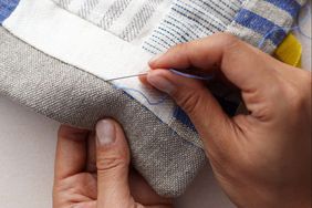 stitching a patchwork quilt