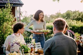 Woman hosting outdoor dinner party