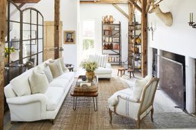 rustic living room with fireplace and white furniture