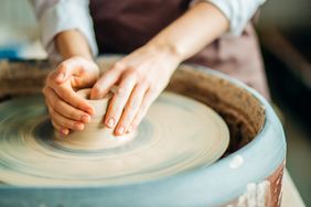 hands creating pottery