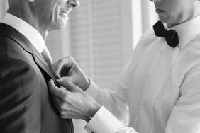 vanessa nathan wedding groom pinning brooch on father