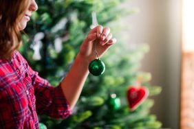 woman decorating Christmas tree